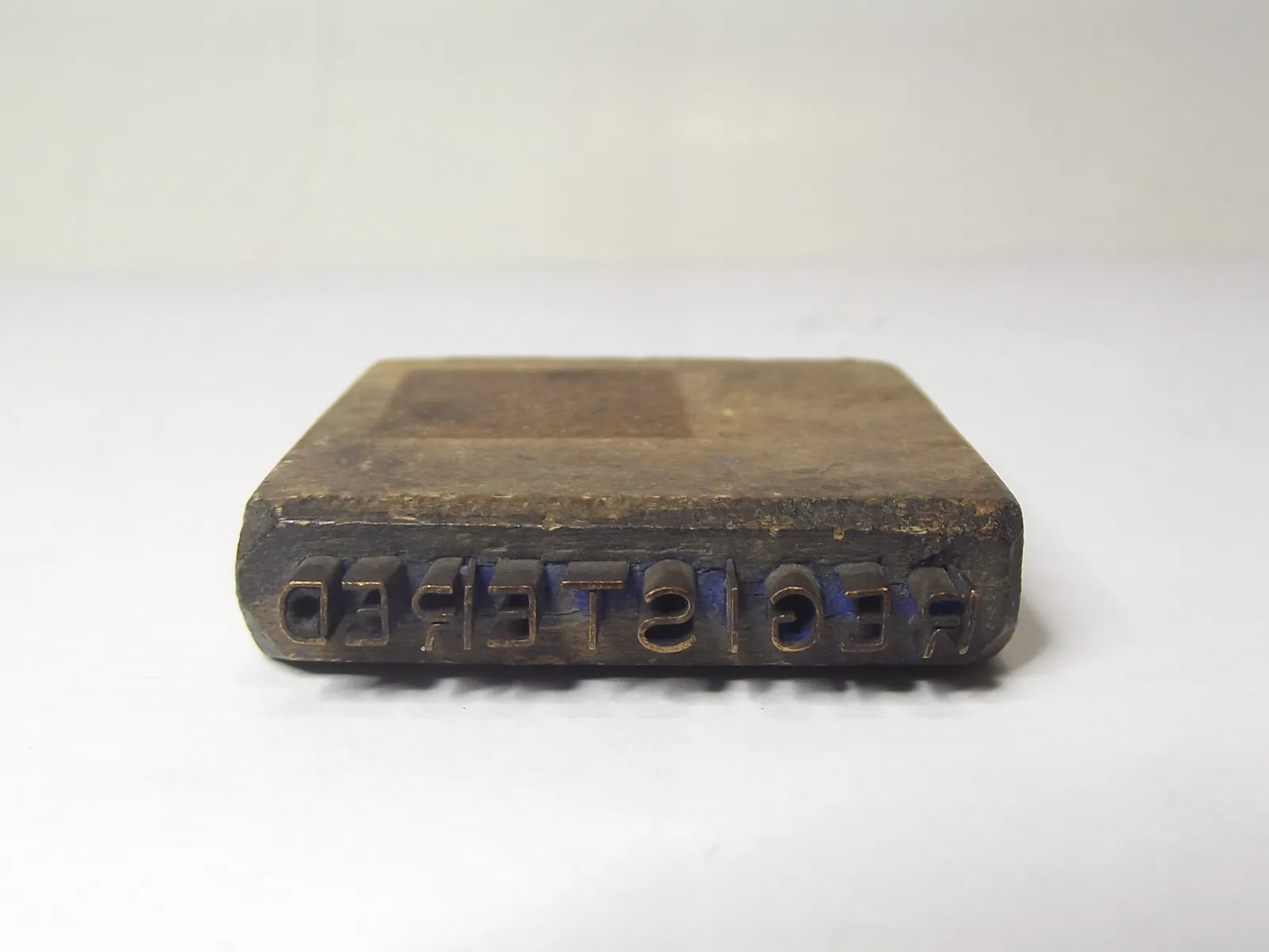 Sello de metal con base de madera